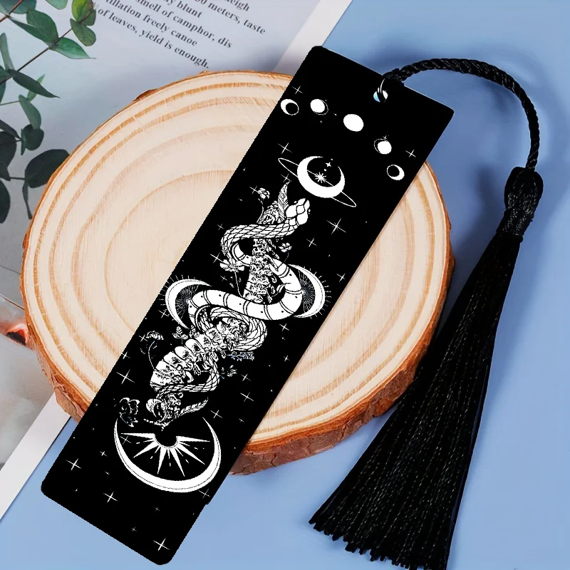 Black bookmark with white design on a wooden surface