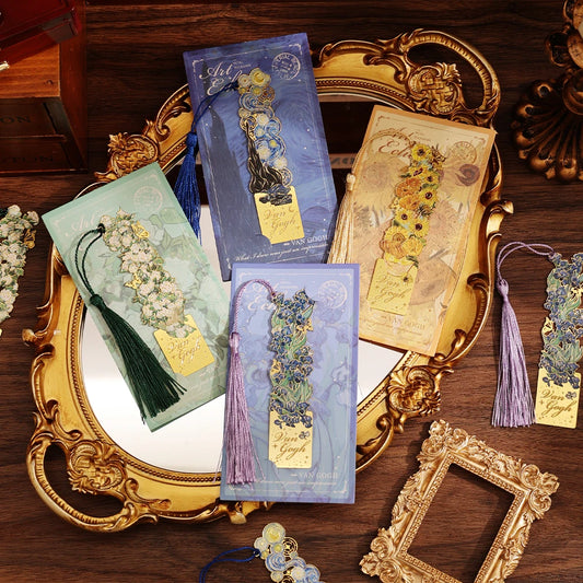 Decorative bookmarks with tassels on a wooden surface with ornate gold frames.