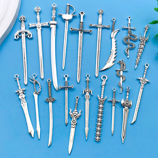 Collection of silver sword-shaped jewelry on a blue background