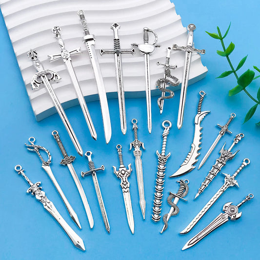 Collection of silver sword-shaped jewelry on a blue background