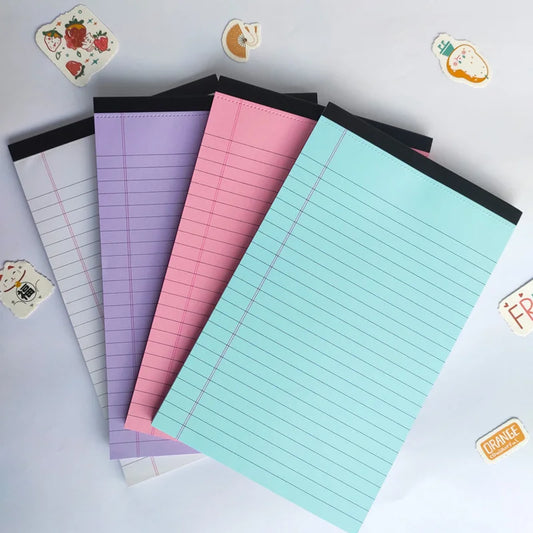 Set of colorful lined notepads on a light gray background