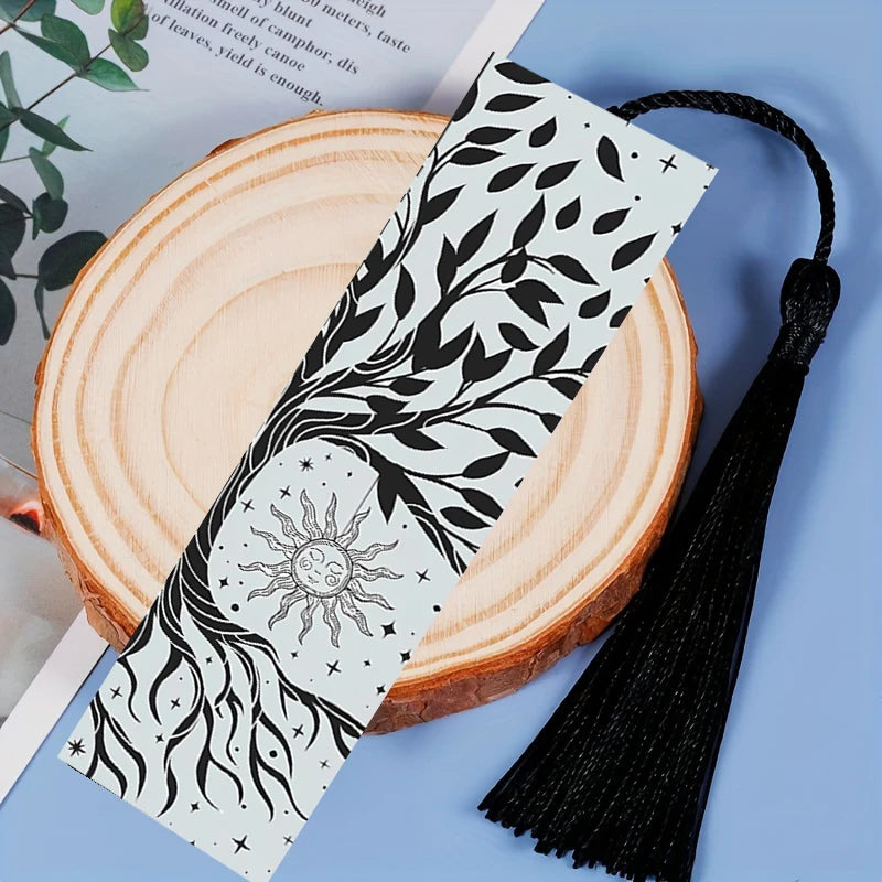 Decorative face mask with black leaf pattern on a wooden surface