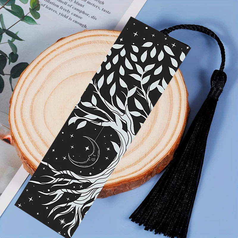 Black and white patterned bookmark with tassel on a wooden surface