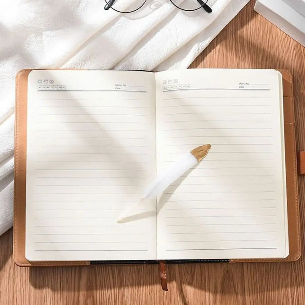 Open notebook with lined pages on a wooden surface
