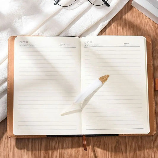Open notebook with lined pages on a wooden surface