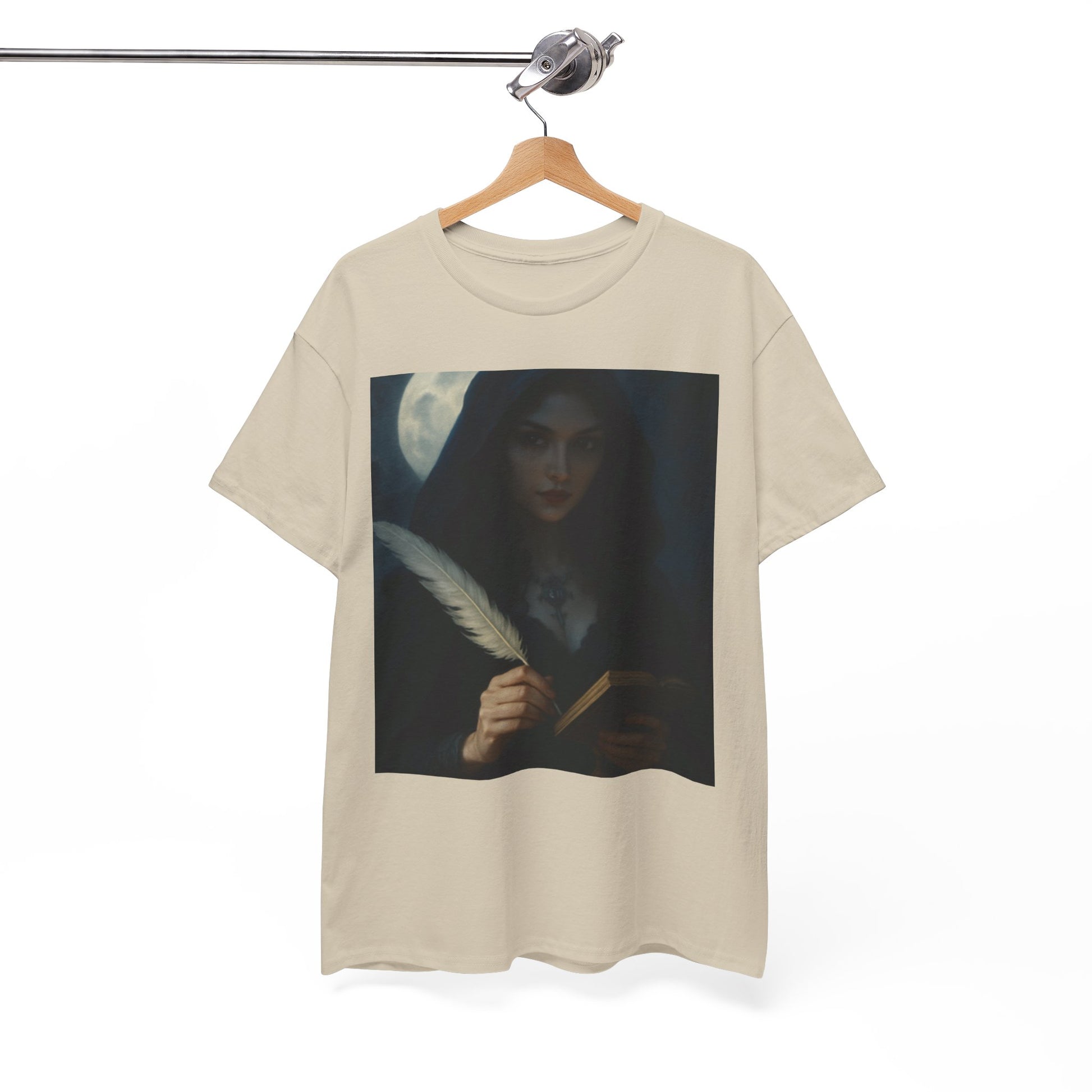 Beige t-shirt with a graphic of a woman holding a feather pen and a book on a hanger against a white background.